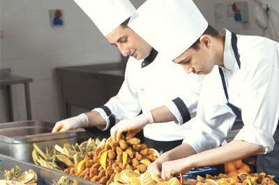 Kitchen  staff prepping food.